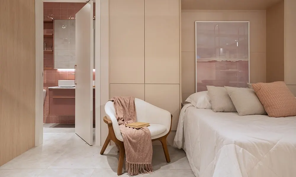 Quarto em tons rosados com poltrona